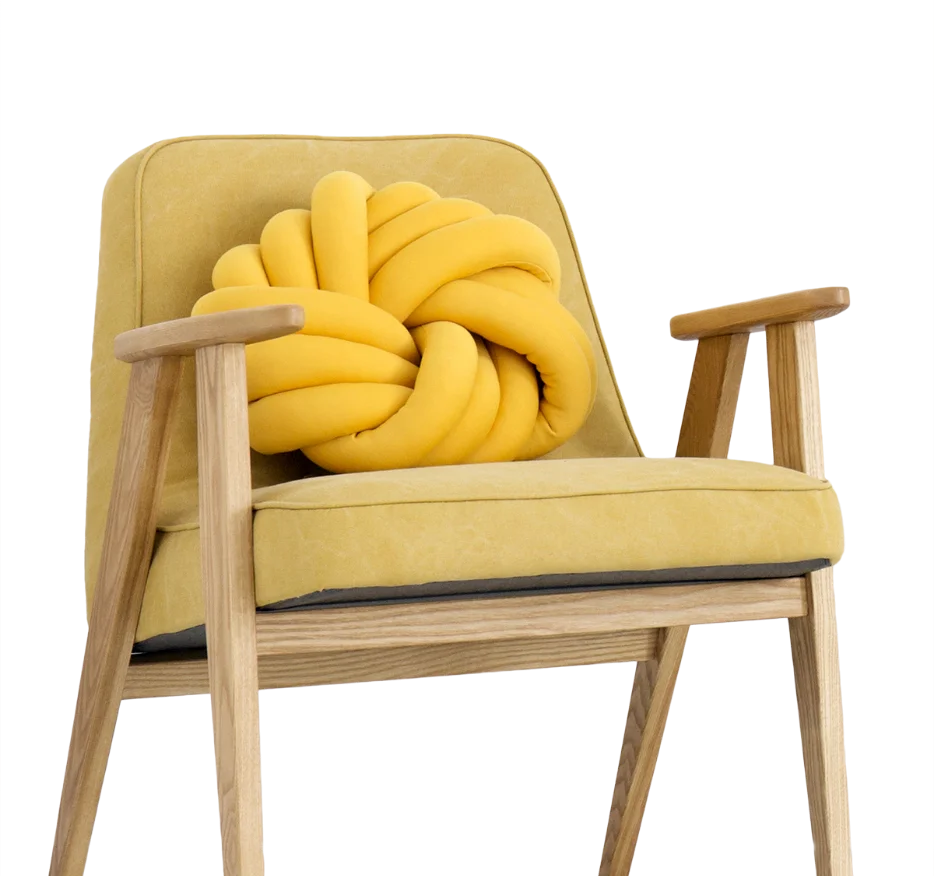 A mustard armchair with a knotted cushion