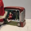 1760960509_WhatsApp_Image_2025-10-04_at_2.41.47_PM-1.jpeg Retro Radio Santa Figurine – Whimsical Holiday Scene