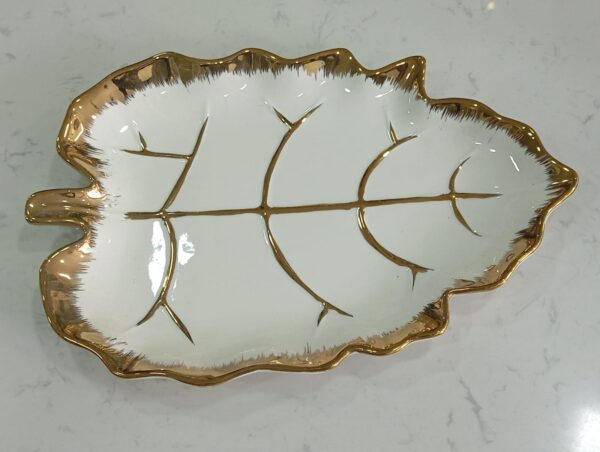 1781247881_WhatsApp_Image_2026-06-09_at_13.21.25-1.jpeg Leaf-Shaped White Ceramic Serving Dish with Gold Vein Detailing