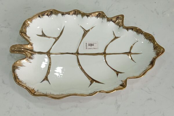 1781247883_WhatsApp_Image_2026-06-09_at_13.21.57-1.jpeg Leaf-Shaped White Ceramic Serving Dish with Gold Vein Detailing