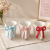 1787139547_ChatGPT_Image_Aug_19_2026_04_55_05_PM-1.png Charming Bow Accent Ceramic Mug